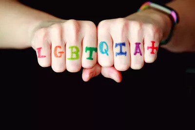 LGBTQ+ written across someone's hands | Covenant House LGBTQ+ homeless youth