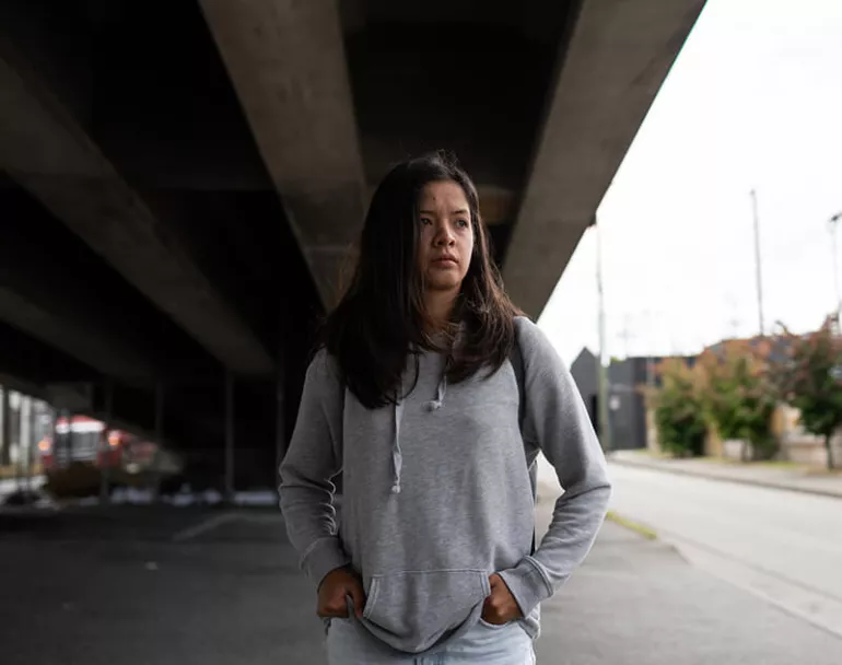Homeless young woman under bridge