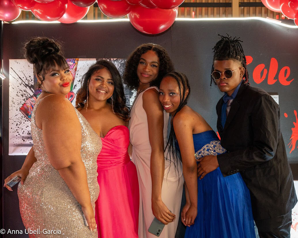 Young adults posing for a photo at Pride Prom
