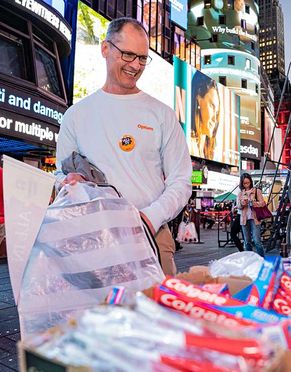 Covenant House Volunteer packing outreach kits for homeless kids in Times Square NYC