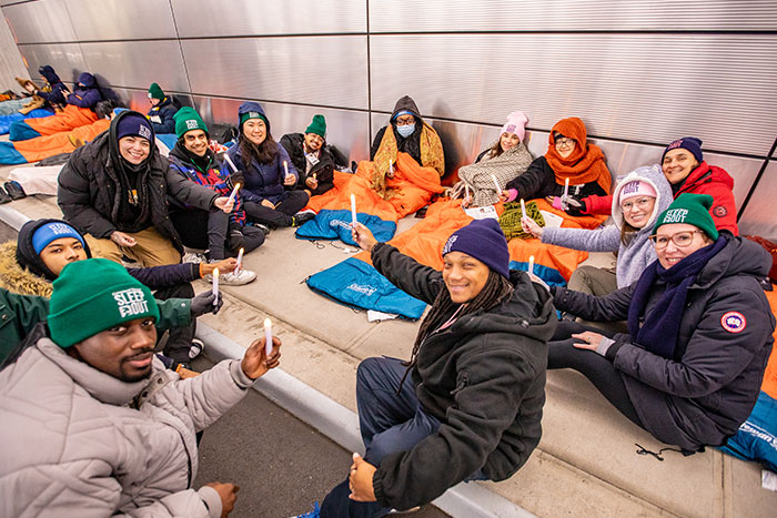 Covenant House Sleep Out Volunteers sitting on sleeping bags and holding vigils in Times Square NYC