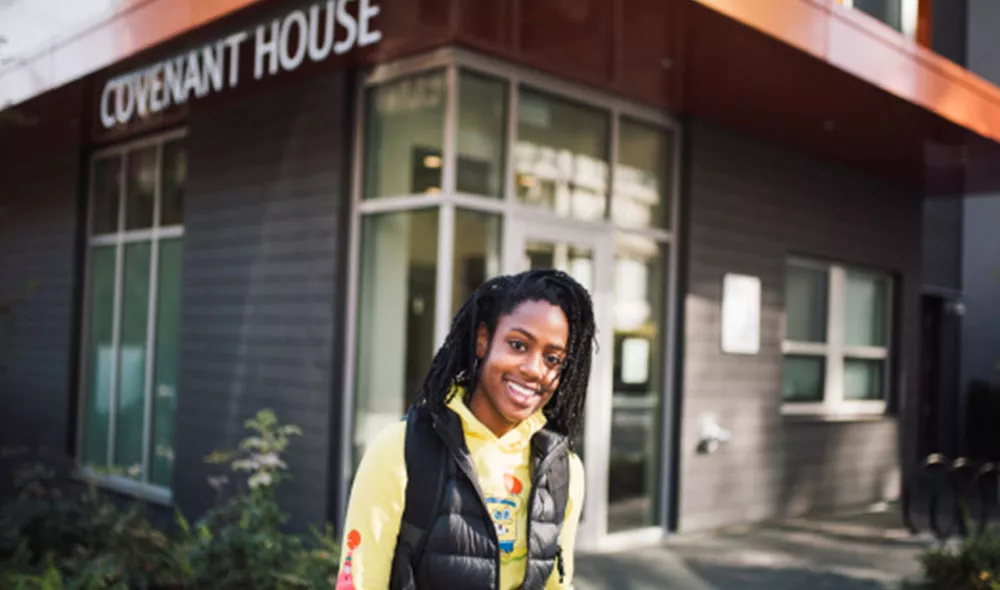 Smiling youth in front of Covenant House building