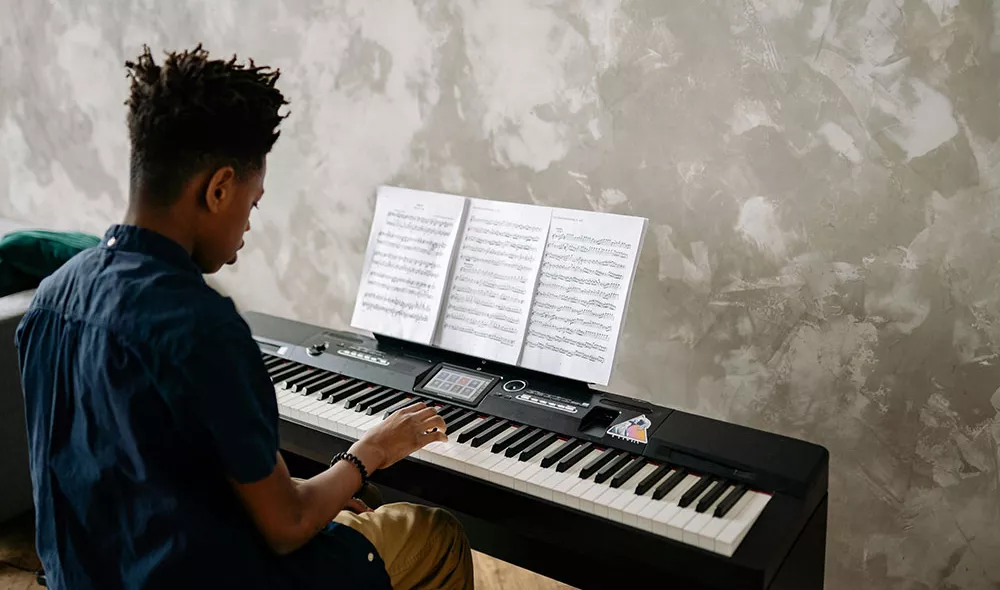 former homeless teen playing piano | Music Therapy at Covenant House