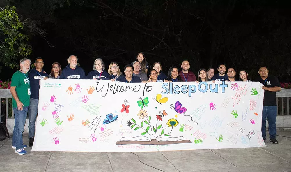 Covenant House Honduras Sleep Out volunteers and staff holding sleep out banner