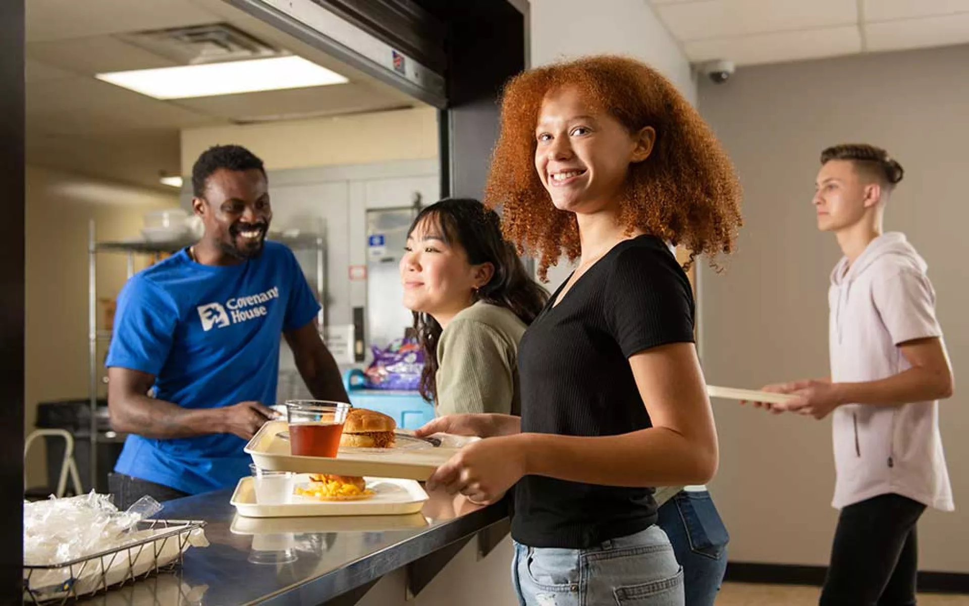 Former homeless youth getting meals at cafeteria | Covenant House