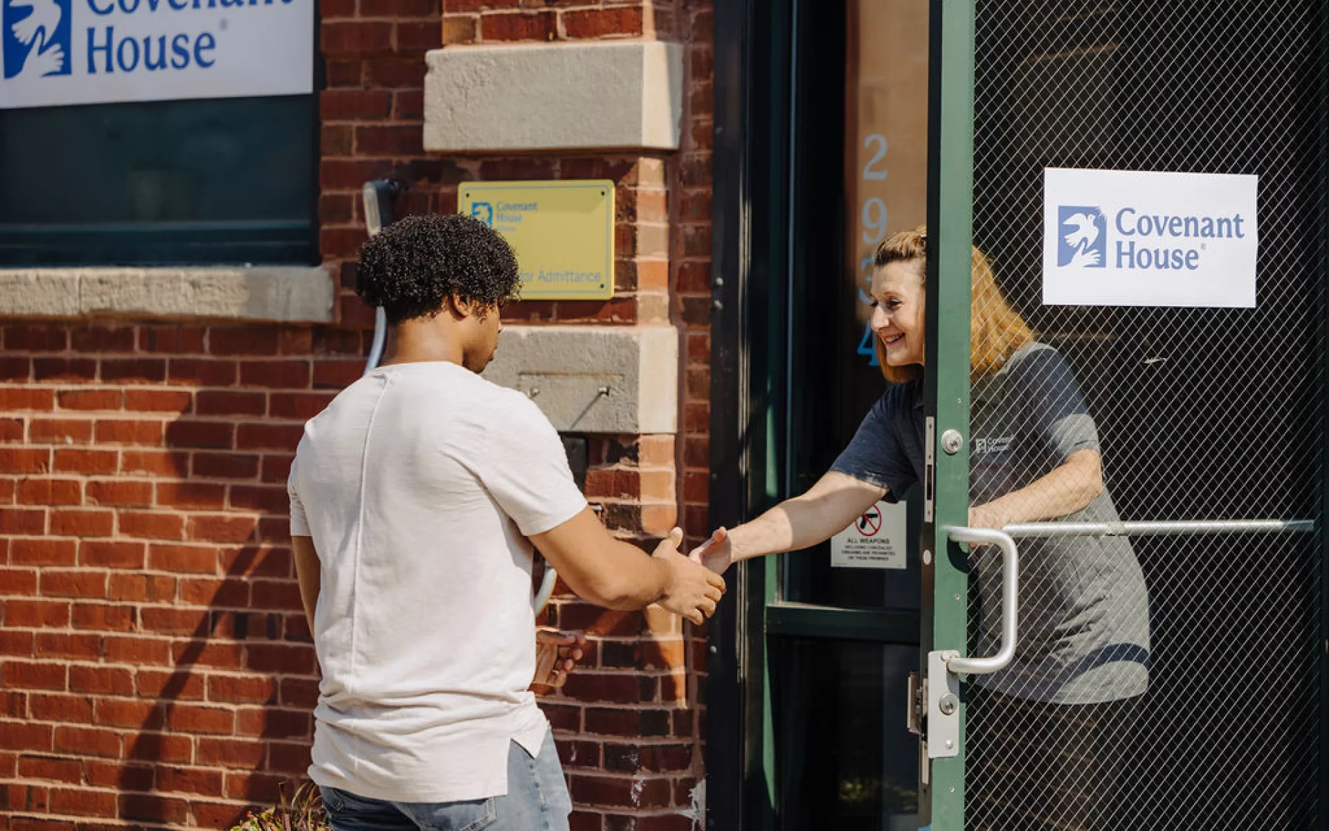 BIPOC Teen entering Covenant House Chicago homeless shelter 