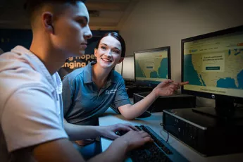 Young man learning about the Covenant House mission at a computer