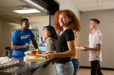 Young lady receiving food in a Covenant House Cafeteria