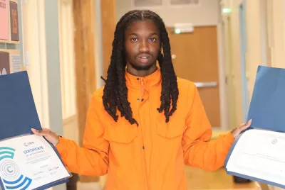 Covenant House Illinois David holding up certificates