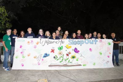 Covenant House Honduras Sleep Out volunteers and staff holding sleep out banner