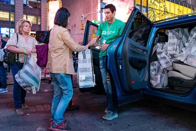 Covenant House Volunteer and donor at Times Square with essential kits for homeless youth | Youth Homelessness Awareness Month