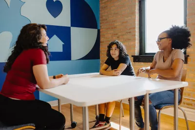 group of homeless youth talking at a table at Covenant House