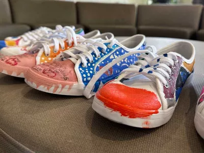 Covenant House Michigan homeless youth/artists transformed pairs of sneakers into a colorful representation of their journey