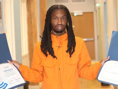 Covenant House Illinois David holding up certificates