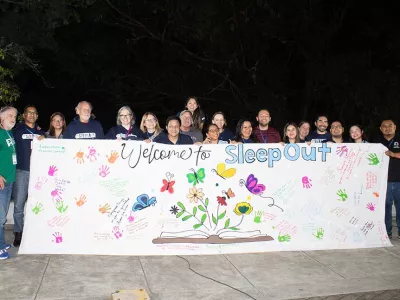 Covenant House Honduras Sleep Out volunteers and staff holding sleep out banner