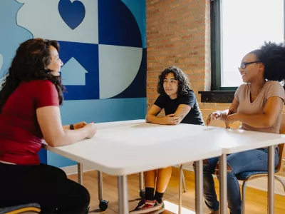 group of homeless youth talking at a table at Covenant House