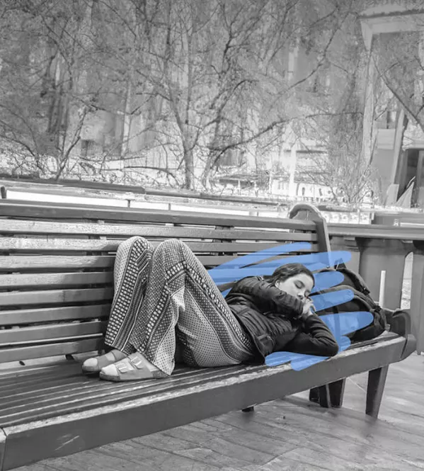 Homeless youth sleeping on park bench