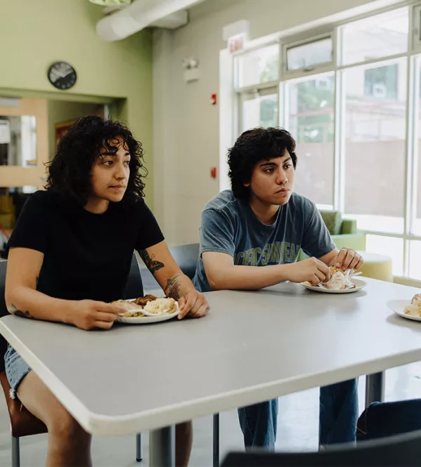 Covenant House former homeless teens in cafeteria with meals | Donate Today for our 4X Match