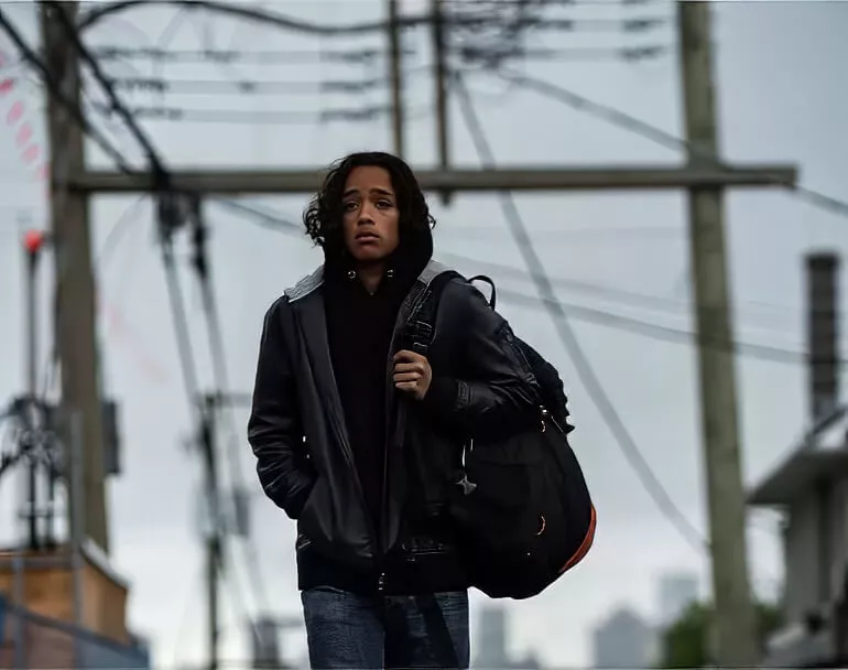 Young man walking outdoors with a backpack