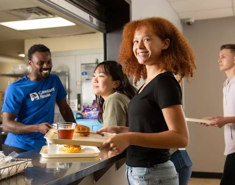 Former homeless youth getting meals at cafeteria | Covenant House