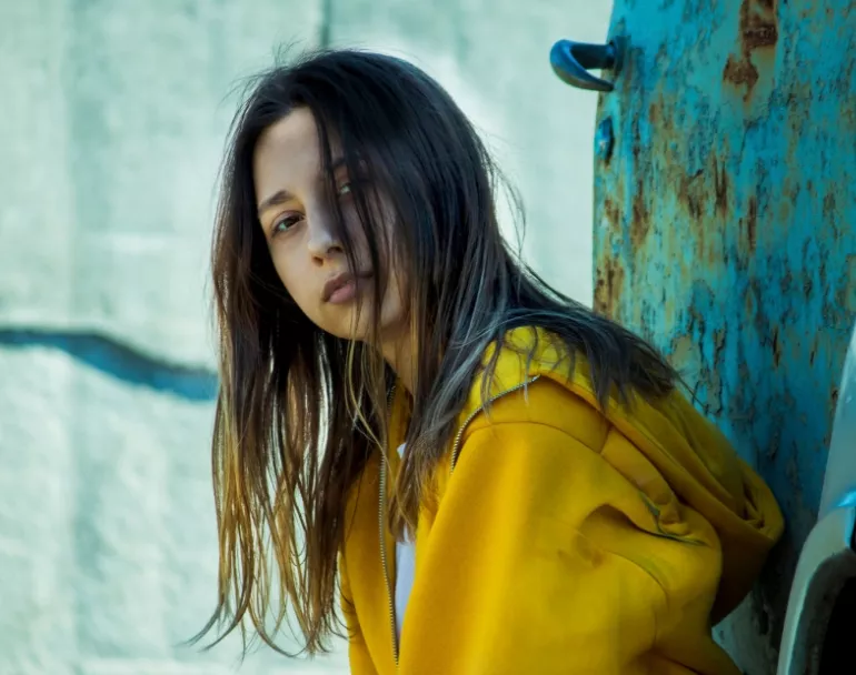 Homeless girl leaning against wall | Covenant House