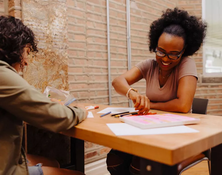 previously homeless teen girls doign arts and crafts in recreational room | Covenant House