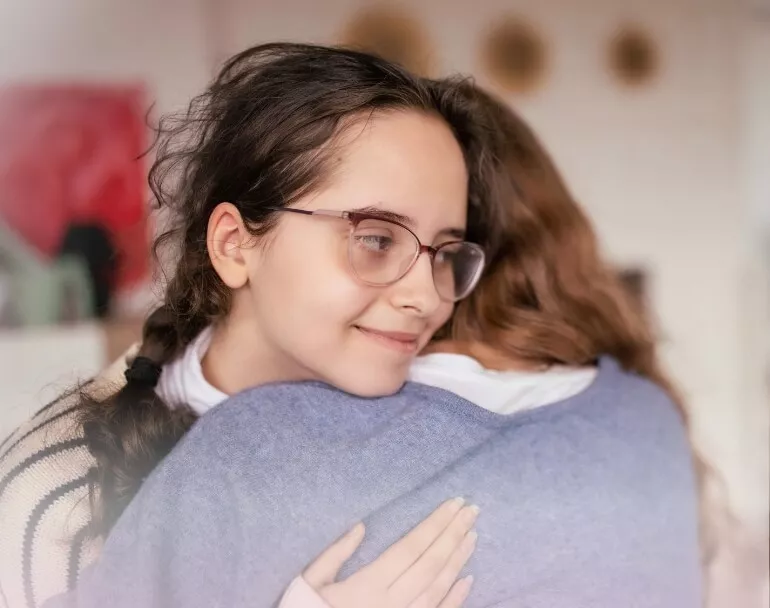former homeless youth giving each other a hug | Covenant House - Be an Angel Day