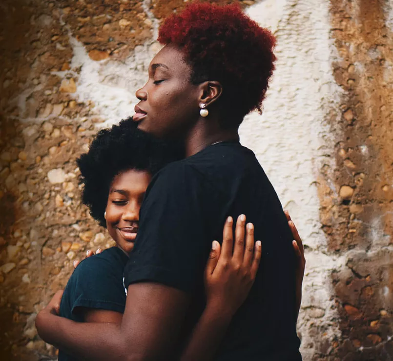 Young mother facing homelessness hugging her daughter