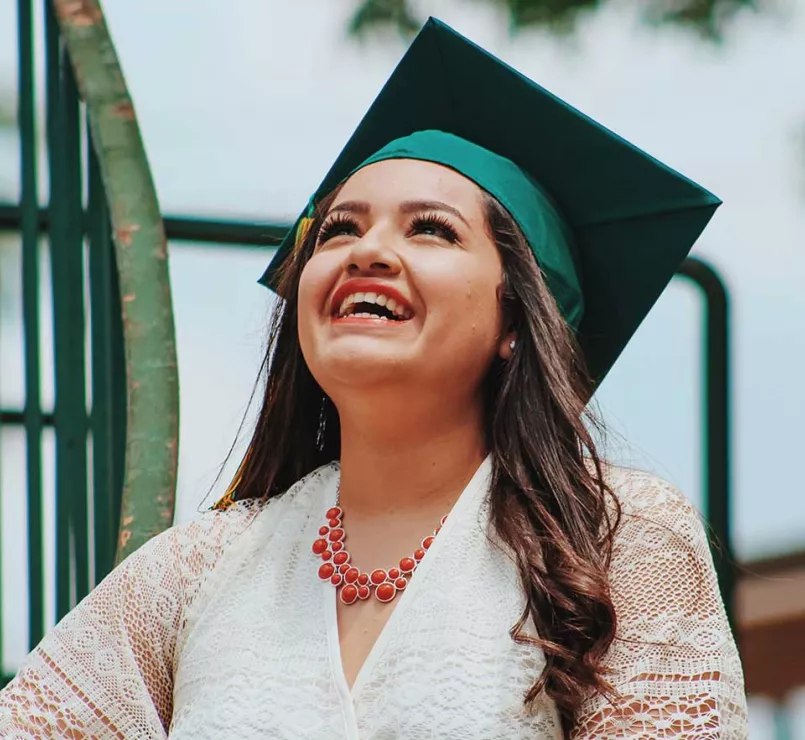 former homeless youth with graduation cap | Covenant House education and workforce development