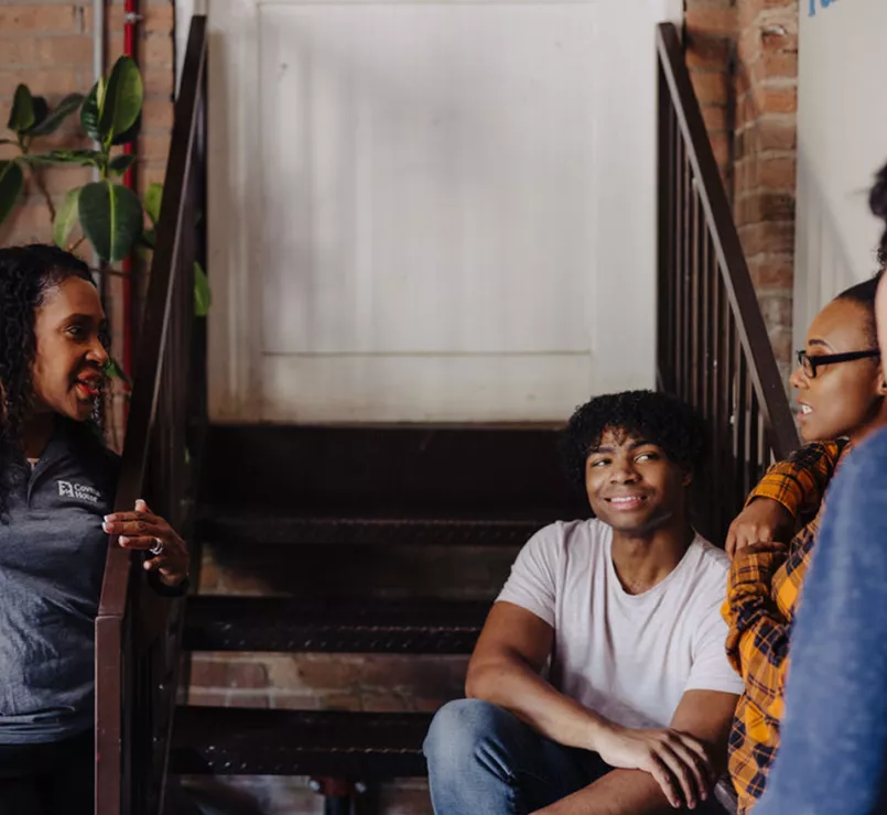 Covenant House youth and staff on a staircase 